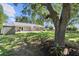 Expansive backyard featuring a patio, pergola, storage shed, and mature trees offering privacy at 15917 Hidden Lake Cir, Clermont, FL 34711