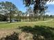 Scenic view of a backyard pond with a walking trail and plenty of trees, offering a tranquil setting at 15917 Hidden Lake Cir, Clermont, FL 34711