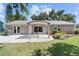 Charming backyard featuring a patio, pergola, well-maintained lawn and landscaping for outdoor enjoyment at 15917 Hidden Lake Cir, Clermont, FL 34711