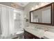Cozy bathroom with a tub shower, marble countertop, and decorative elements for a spa-like feel at 15917 Hidden Lake Cir, Clermont, FL 34711