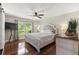 Bedroom with hardwood floors, a large window, and stylish furnishings at 15917 Hidden Lake Cir, Clermont, FL 34711