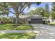 Charming single story home with lush landscaping, well-maintained lawn and a 2-car garage at 15917 Hidden Lake Cir, Clermont, FL 34711