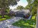 Single story home with mature trees, well-maintained lawn and long driveway to a 2-car garage at 15917 Hidden Lake Cir, Clermont, FL 34711