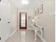 Light and airy foyer with an eye-catching front door, chandelier and white furniture at 15917 Hidden Lake Cir, Clermont, FL 34711