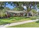 Charming single-story home with a lush front yard and mature trees providing ample shade at 15917 Hidden Lake Cir, Clermont, FL 34711