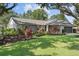 Charming home featuring lush landscaping, a well-manicured lawn, and inviting curb appeal at 15917 Hidden Lake Cir, Clermont, FL 34711