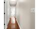 Hallway featuring hardwood floors and several doorways at 15917 Hidden Lake Cir, Clermont, FL 34711