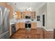 Kitchen with wooden cabinets, stainless steel appliances, and tile backsplash at 15917 Hidden Lake Cir, Clermont, FL 34711