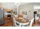 Eat-in kitchen featuring hardwood floors, modern cabinets, and stainless steel appliances at 15917 Hidden Lake Cir, Clermont, FL 34711
