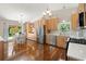 Eat-in kitchen featuring hardwood floors, wooden cabinets, stainless steel appliances, and lots of natural light at 15917 Hidden Lake Cir, Clermont, FL 34711