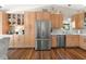 Well-lit kitchen with wooden cabinets, stainless steel appliances, and white countertops at 15917 Hidden Lake Cir, Clermont, FL 34711
