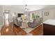 Inviting living room with hardwood floors, a large screen TV, and sliding doors to the outside at 15917 Hidden Lake Cir, Clermont, FL 34711