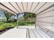 Under a pergola with a view of the lush backyard, combining shade and scenery at 15917 Hidden Lake Cir, Clermont, FL 34711