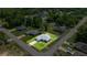 Aerial view of a home with well-manicured lawn and landscaping in a suburban neighborhood at 16062 Se 89Th Ter, Summerfield, FL 34491