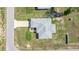 Aerial view of home and yard, highlighting the roof and driveway, set in a suburban landscape at 16062 Se 89Th Ter, Summerfield, FL 34491