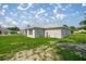 A view of the backyard with a green lawn, showcasing the exterior of the single-story home at 16062 Se 89Th Ter, Summerfield, FL 34491