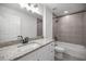 The bathroom features a single vanity with granite countertops, framed mirror, and a shower-tub combo at 16062 Se 89Th Ter, Summerfield, FL 34491