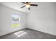 A spacious, sunlit bedroom features neutral gray carpeting and a ceiling fan at 16062 Se 89Th Ter, Summerfield, FL 34491