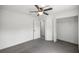 A bright bedroom with neutral gray carpeting offers access to the closet and adjoining room at 16062 Se 89Th Ter, Summerfield, FL 34491