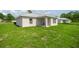 The exterior of a well-maintained single-story home with a green lawn and neutral paint at 16062 Se 89Th Ter, Summerfield, FL 34491
