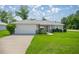 Charming single-story home with a well-manicured lawn, a two car garage and lovely landscaping at 16062 Se 89Th Ter, Summerfield, FL 34491