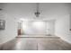 A clean, spacious two-car garage featuring concrete floors and white-painted block walls at 16062 Se 89Th Ter, Summerfield, FL 34491