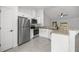 Updated kitchen with granite counters, stainless appliances, and white cabinetry at 16062 Se 89Th Ter, Summerfield, FL 34491