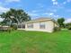 The back of the house is surrounded by a well-maintained lawn and mature trees, offering privacy at 17233 Se 115Th Terrace Rd, Summerfield, FL 34491