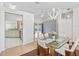 Open concept dining area with modern light fixture, hardwood floors, and open view into the living room at 17233 Se 115Th Terrace Rd, Summerfield, FL 34491