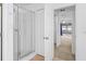 Hallway view featuring shower stall, closets, and view to sunroom with lots of windows at 17233 Se 115Th Terrace Rd, Summerfield, FL 34491