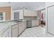 Well-equipped kitchen with stainless appliances, light cabinets, and ample countertop space perfect for cooking at 17233 Se 115Th Terrace Rd, Summerfield, FL 34491