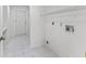 Laundry area featuring tile flooring, utility sink hook ups, and access to exterior at 17233 Se 115Th Terrace Rd, Summerfield, FL 34491