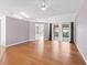 Open living room featuring hardwood floors, ceiling fan, recessed lighting and sliding doors to lanai at 17233 Se 115Th Terrace Rd, Summerfield, FL 34491