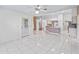 Open-concept living area with tile flooring and access to kitchen at 17233 Se 115Th Terrace Rd, Summerfield, FL 34491