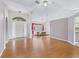 Bright living room showcasing hardwood floors, high ceilings, and an open view into the dining area at 17233 Se 115Th Terrace Rd, Summerfield, FL 34491