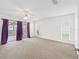 Bright main bedroom with carpet floors and sliding door access to the patio at 17233 Se 115Th Terrace Rd, Summerfield, FL 34491