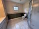 Bathroom with a toilet, shower, tile flooring and vintage style at 17522 Se 96Th Ct, Summerfield, FL 34491