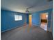 Bedroom featuring blue walls, carpet flooring, and a window with natural light at 17522 Se 96Th Ct, Summerfield, FL 34491