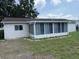 Home exterior showcases a screened-in porch, enhancing outdoor living with a yard at 17522 Se 96Th Ct, Summerfield, FL 34491
