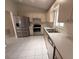 Bright kitchen with stainless steel appliances and white countertops at 17522 Se 96Th Ct, Summerfield, FL 34491