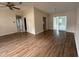 Open-concept living room with wood floors and sliding glass doors to a sunroom at 17522 Se 96Th Ct, Summerfield, FL 34491