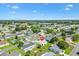 Desirable community showcasing well-maintained homes, lush green lawns, and mature trees on a sunny day at 17576 Se 96Th Ct, Summerfield, FL 34491