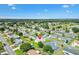 Aerial view of a residential area with well-maintained homes surrounded by lush green trees and a golf course at 17576 Se 96Th Ct, Summerfield, FL 34491