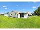 Well-maintained backyard showcasing the home's exterior, featuring a screened-in porch at 17576 Se 96Th Ct, Summerfield, FL 34491