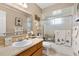 Neutral bathroom with a large mirror, ample counter space, and a shower-tub combination at 17576 Se 96Th Ct, Summerfield, FL 34491
