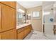 Bathroom with spacious wood vanity and walk-in shower featuring bright natural light at 17576 Se 96Th Ct, Summerfield, FL 34491