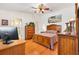 Spacious bedroom featuring wooden furnishings, ceiling fan and bright natural lighting at 17576 Se 96Th Ct, Summerfield, FL 34491