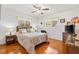 Cozy bedroom with wicker furniture, warm wood floors, and bright natural light at 17576 Se 96Th Ct, Summerfield, FL 34491