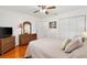 Serene bedroom with soft lighting, a wicker dresser, and large closet perfect for storage at 17576 Se 96Th Ct, Summerfield, FL 34491