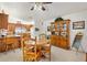 Cozy dining area adjacent to the kitchen, featuring a wooden table and chairs at 17576 Se 96Th Ct, Summerfield, FL 34491